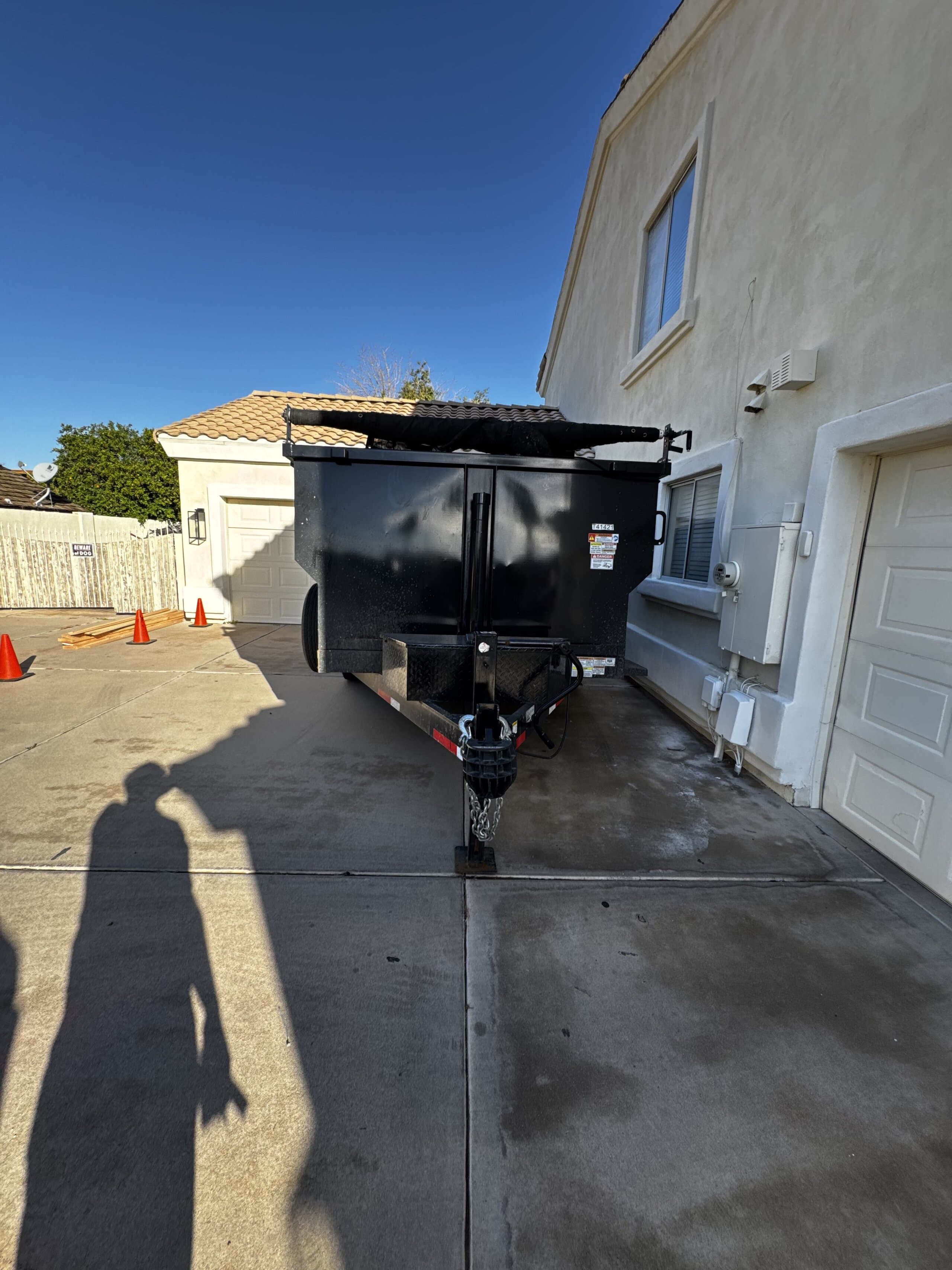 Toss It dump trailer parked in a residential driveway