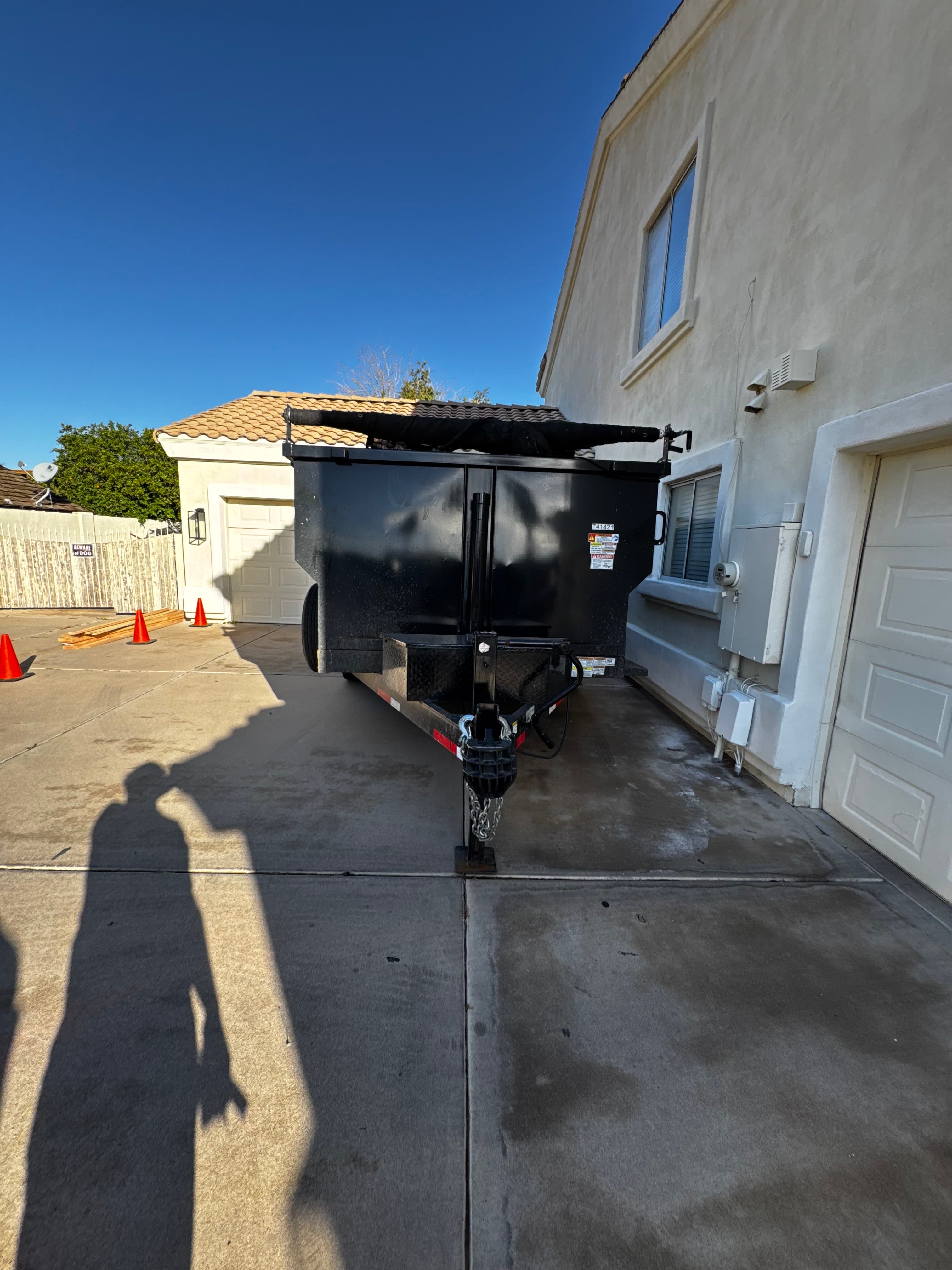 Toss It dump trailer parked in a residential driveway