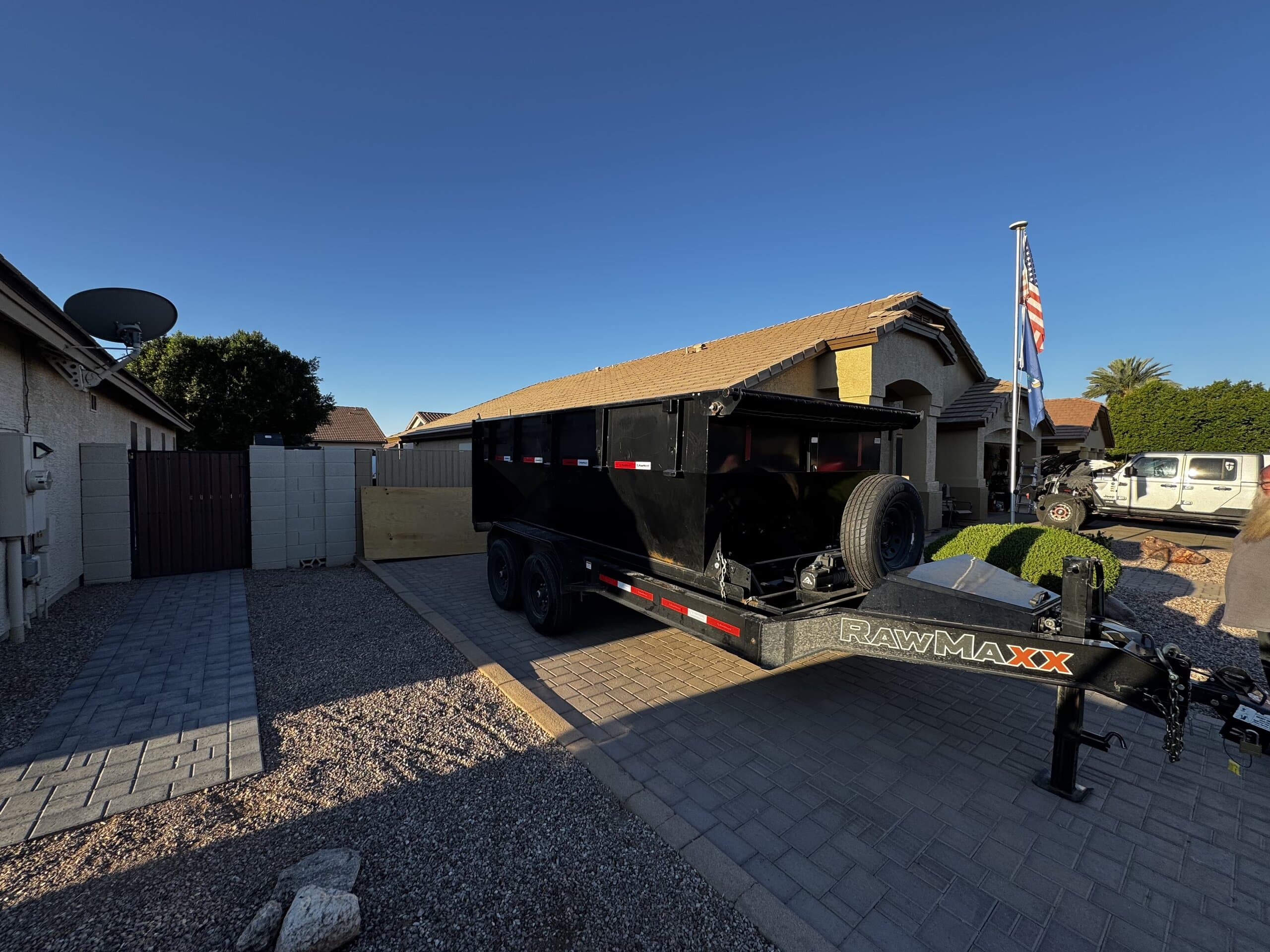 Toss It roll-off dumpster dropped off in a residential driveway