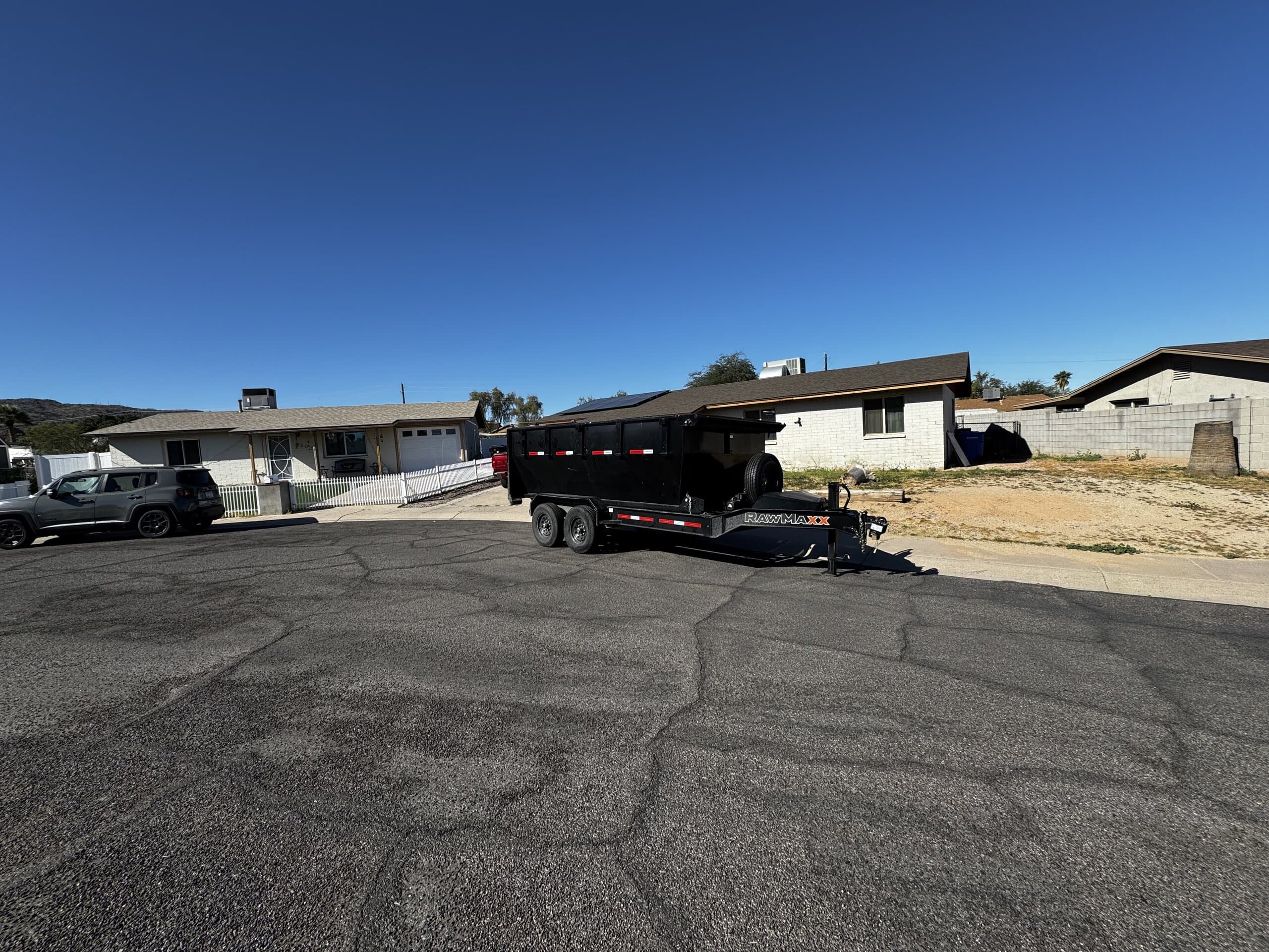 Toss It dump trailer parked on a residential street