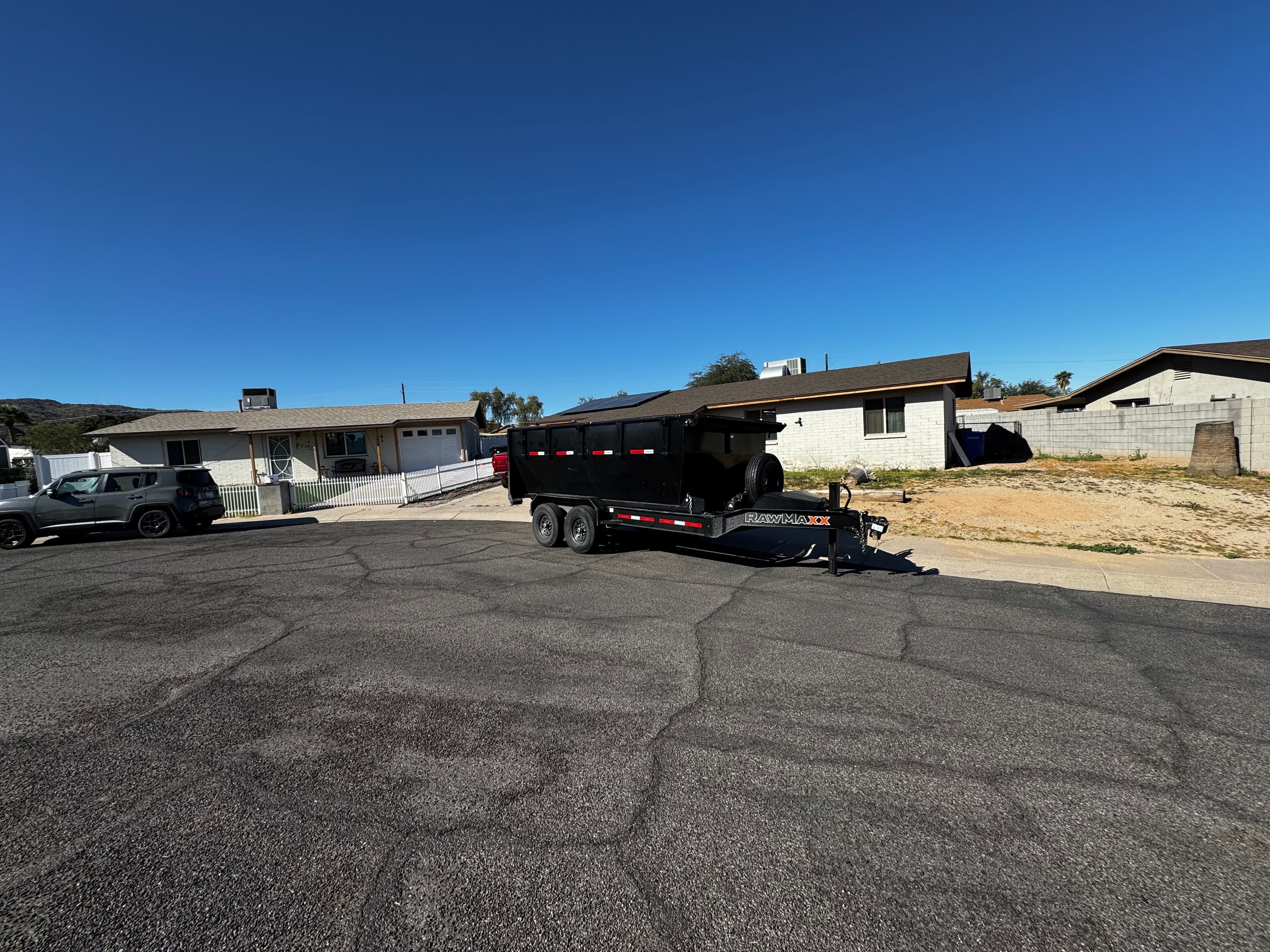 Toss It dump trailer parked on a residential street
